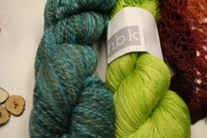 And two skeins of yarn. One hand-spun (spun by her) and then Northbound Knitting's merino silk absinthe color way. The hand-spun is also Northbound knits and it is Shetland colorway force zen.