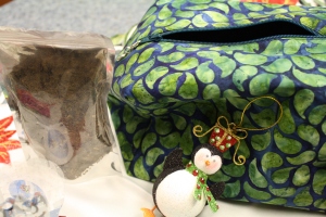 Tea, a project bag, and penguin decoration. 